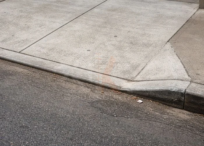 Sidewalk damage caused by tree roots lifting concrete slabs