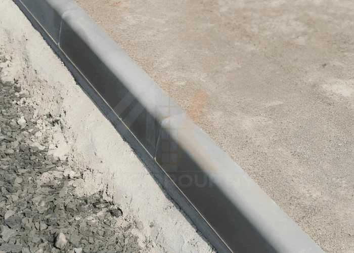 Concrete sidewalk curb repair restoring damaged curb edge in NYC