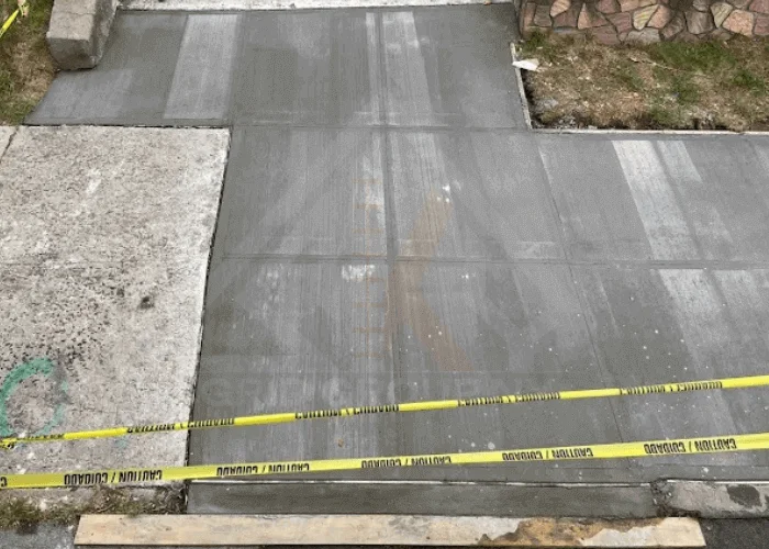 Concrete sidewalk repair fixing cracks and uneven surface