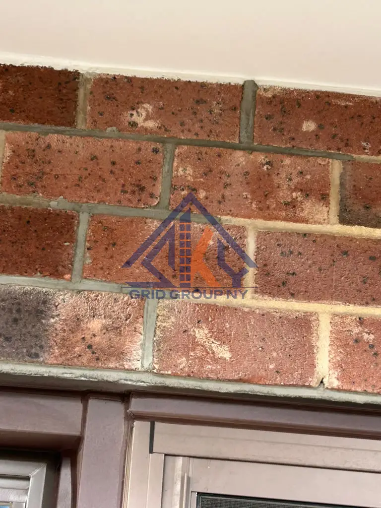 Repointed mortar joints in the brick course above a window head at 46-11 88th Street, Elmhurst