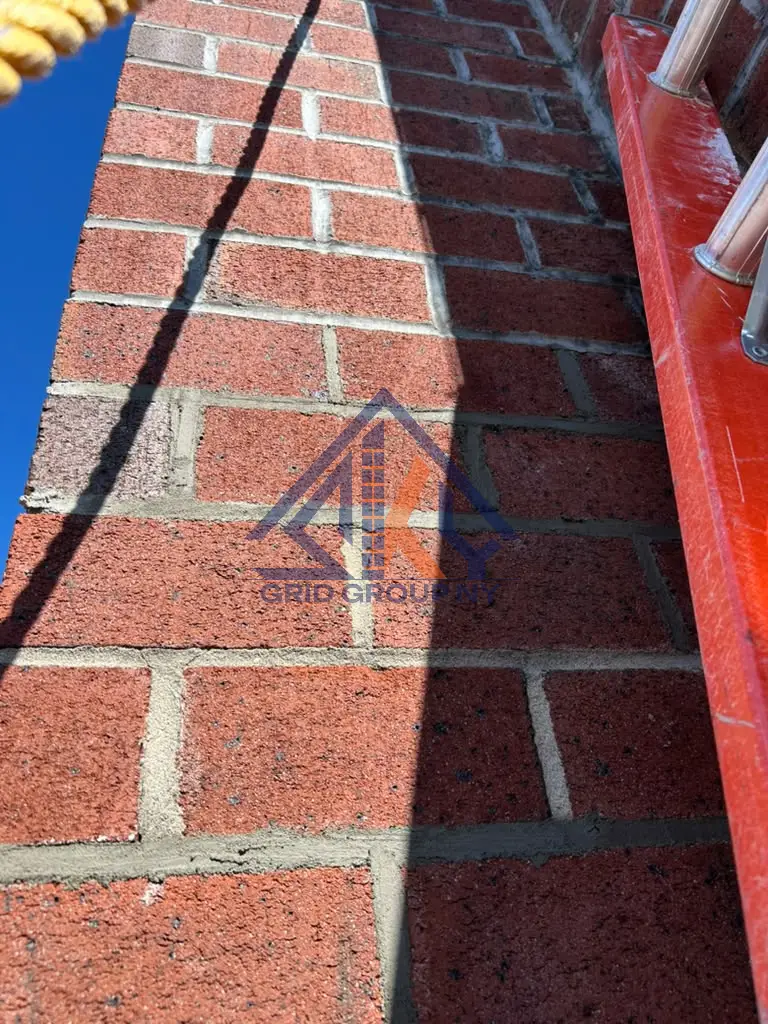 Newly tooled mortar joints wrapping a brick corner on the Elmhurst building