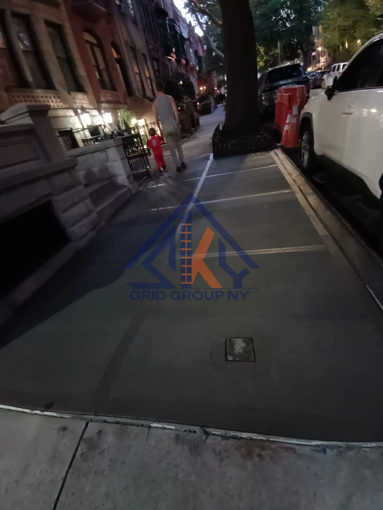 New concrete sidewalk flags with fresh expansion joints along the tree bed on West 131st Street in Central Harlem
